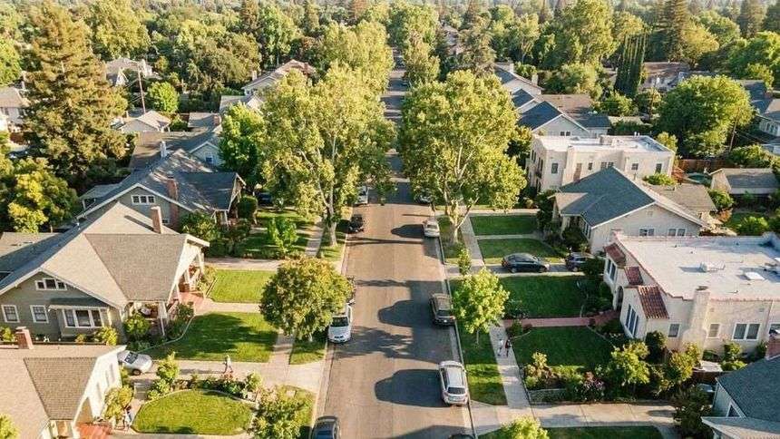 Aerial view of tree-lined Sacramento residential neighborhoods on a sunny day